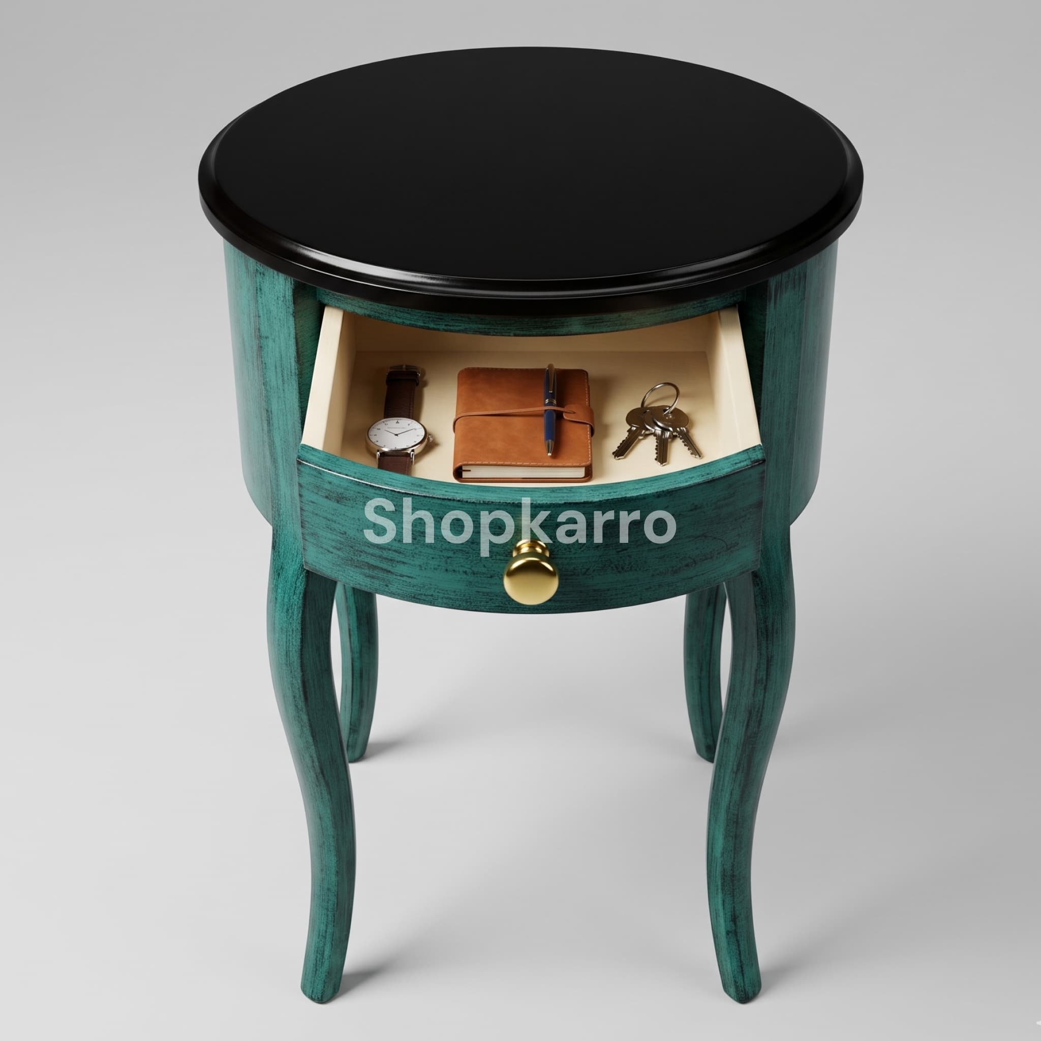 Close-up of two curved drawers with shiny brass gold round knobs on distressed teal side table