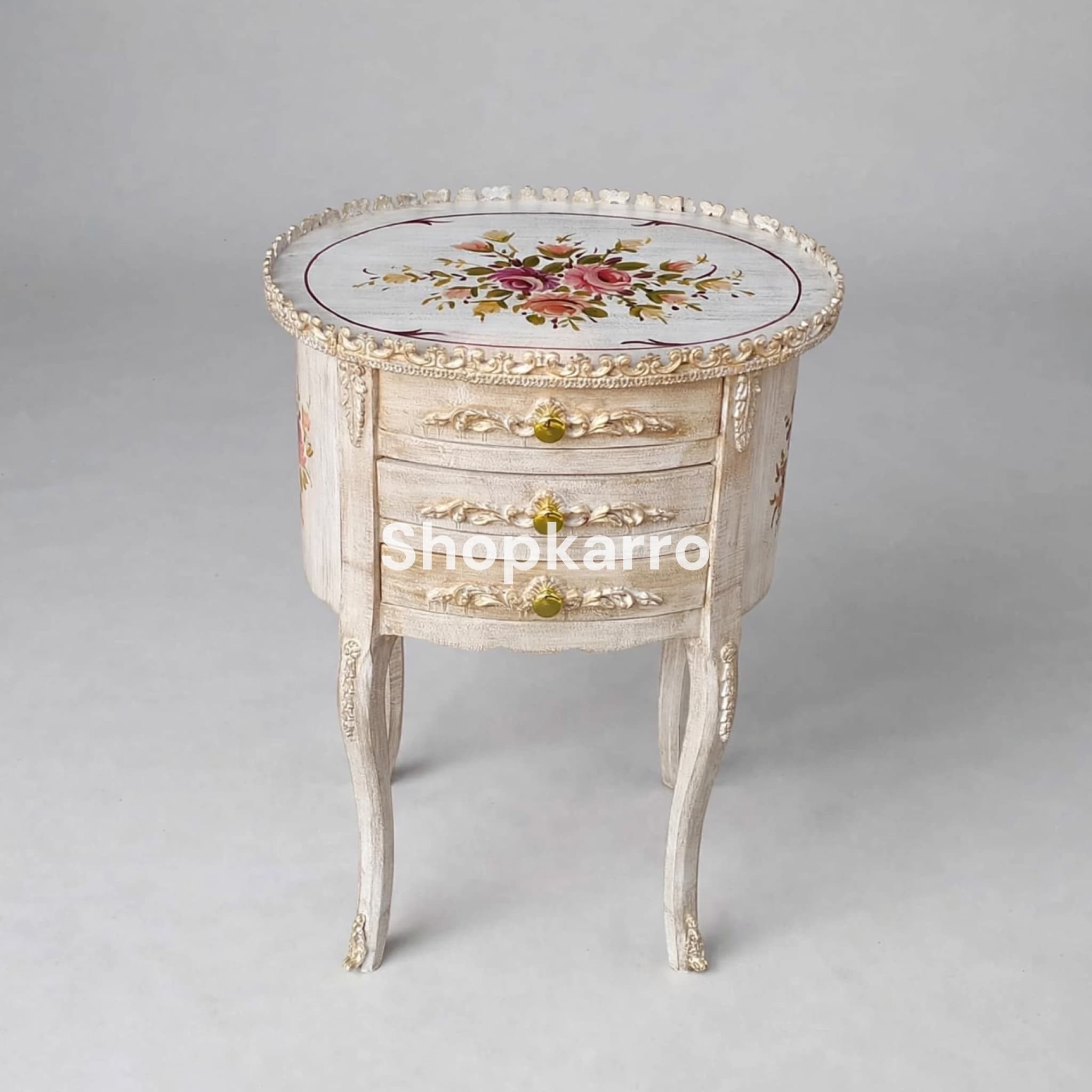 Angled view of Antique Rose Wooden Table showing circular body depth, three drawers and gold claw feet