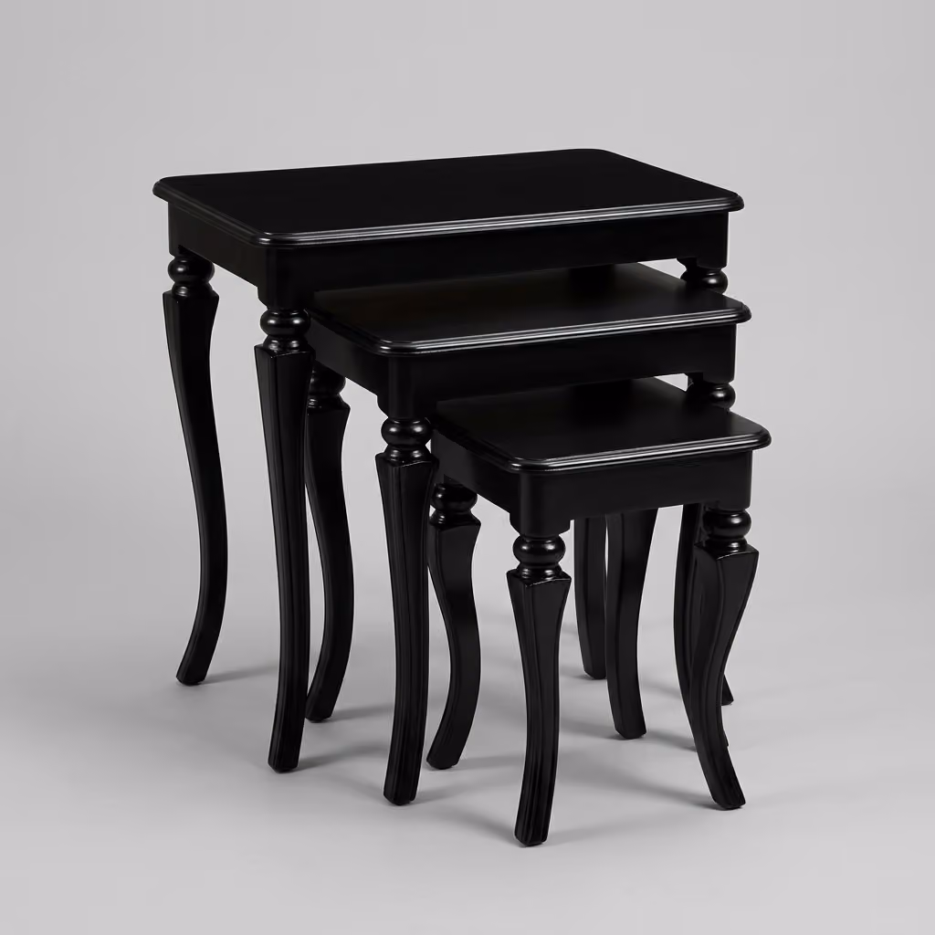 Elegant black nesting coffee tables styled beside sofa on area rug
