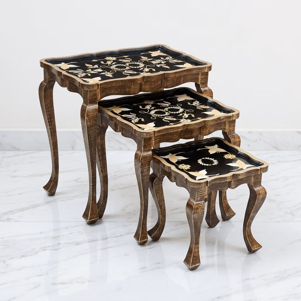 Front view of Vintage Gold Nesting Tables set of 3 nested showing golden crane artwork and antique bronze scalloped frames