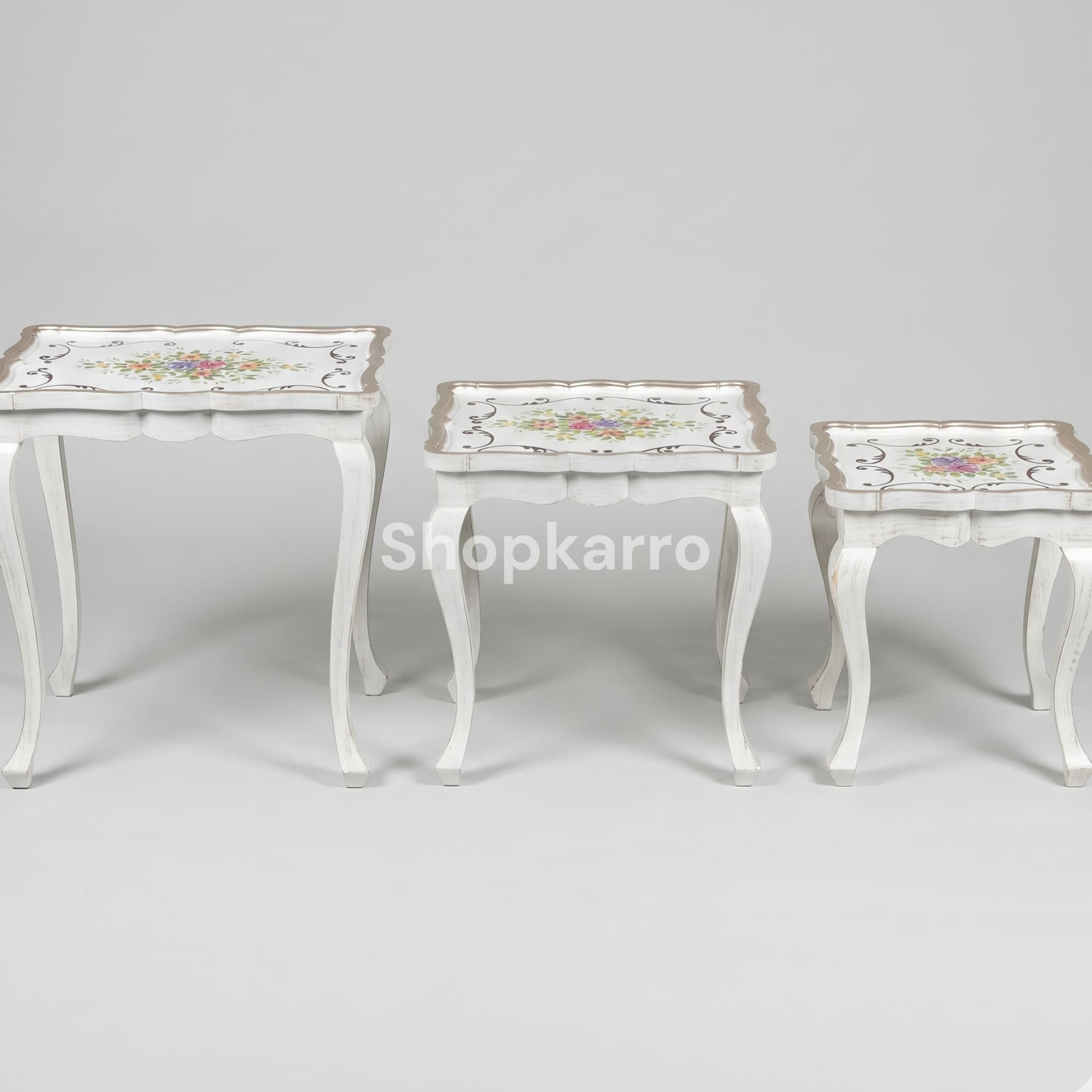 Front view of Artisan Flora Nesting Tables set of 3 stacked nested showing colorful floral tops and white cabriole legs