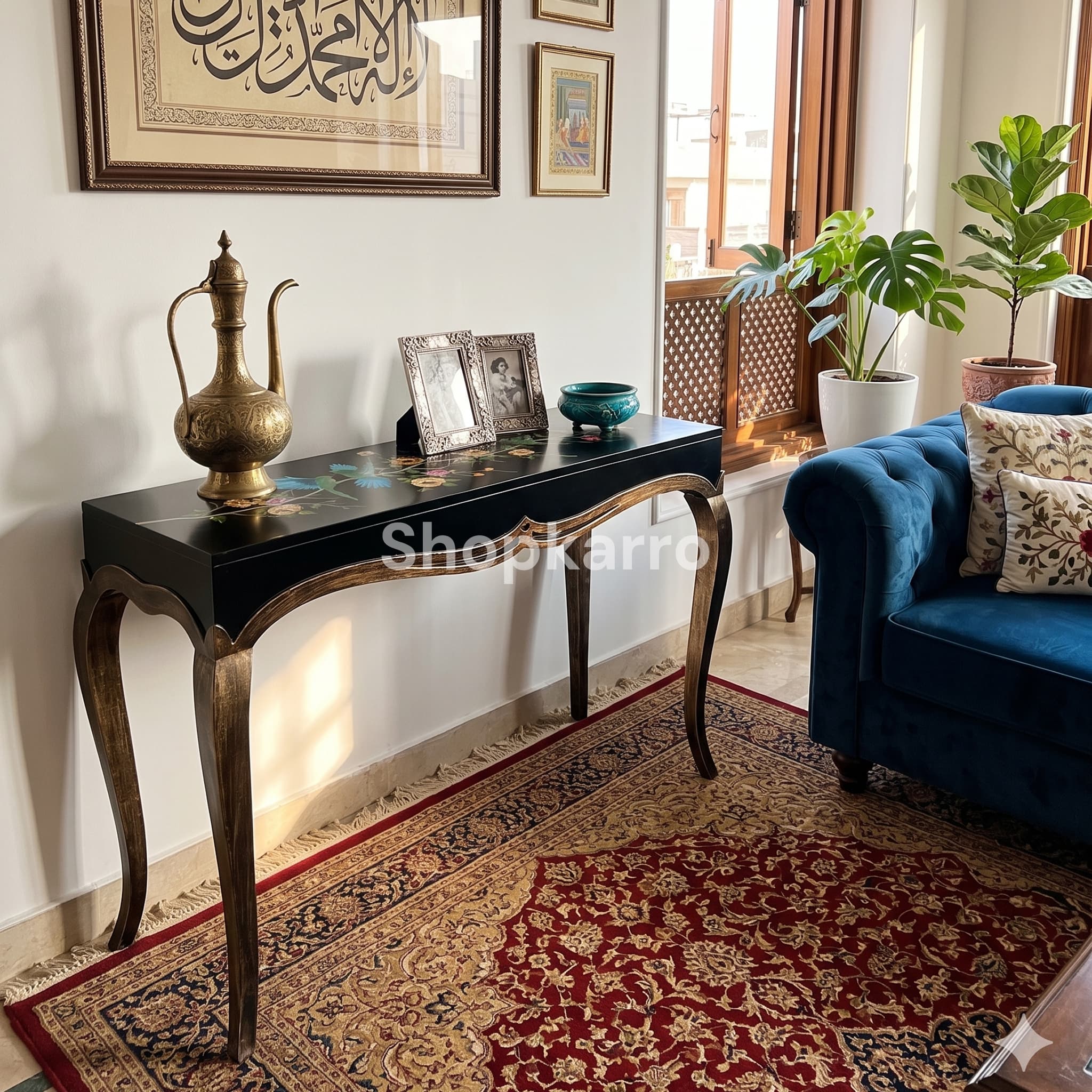 Black console table with bird and flower painting styled in a Pakistani drawing room